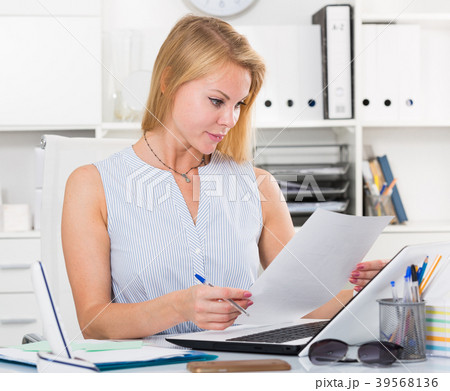 portrait of business woman writing and working with laptop in office 39568136