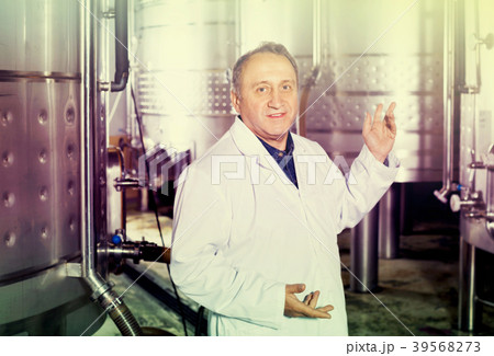 Elderly man in uniform works with equipment Elderly man in uniform works with equipment 39568273