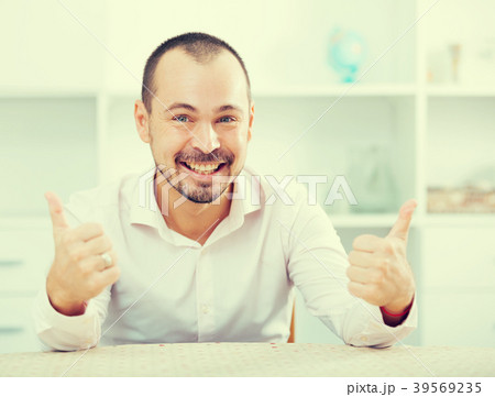 Positive young man in office Positive young man in office 39569235