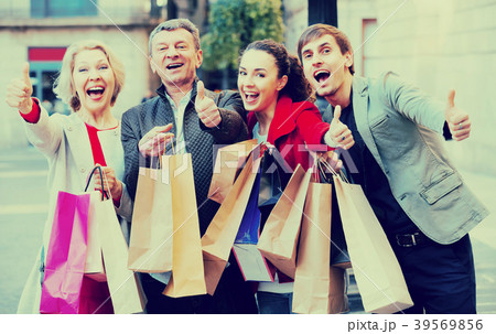 Portrait of adults with packages outdoors. Portrait of adults with packages outdoors. 39569856