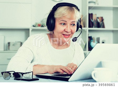 Mature woman communicates via the Internet 39569861