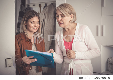 daughter shows some documents of her mother daughter shows some documents of her mother 39570010