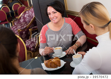 Three woman sitting in cafe Three woman sitting in cafe 39570472