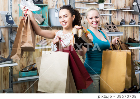 Two young cheerful girls shopping together Two young cheerful girls shopping together 39570708