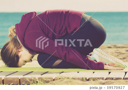 girl exercising on exercise mat outdoor 39570927