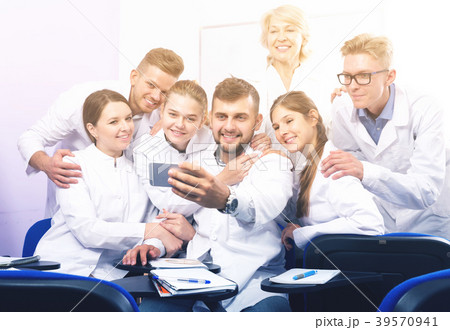 Positive students making selfie indoors Positive students making selfie indoors 39570941