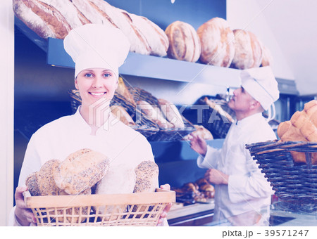 Bakers man and woman are with tasty and fresh bread products Bakers man and woman are with tasty and fresh bread products 39571247