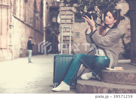 Girl holding camera and photographing Girl holding camera and photographing 39571259