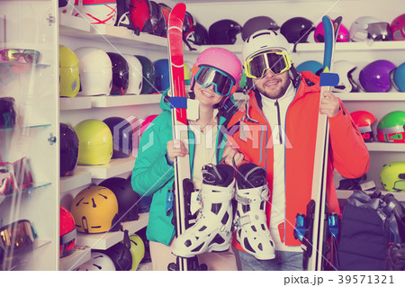 man and woman posing in full skiing gear man and woman posing in full skiing gear 39571321
