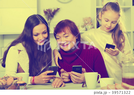 Modern grandmother with family with smartphones 39571322