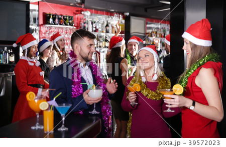 Guy with two girls on new year party in bar 39572023