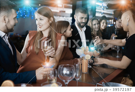 Woman and her boyfriend with cocktails having fun at nightclub 39572197