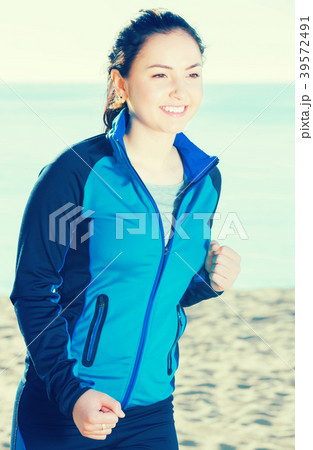 Healthy girl running on beach Healthy girl running on beach 39572491