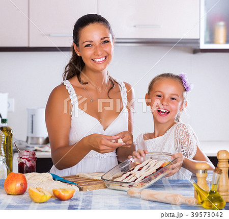 Woman and child cooking strudel Woman and child cooking strudel 39573042
