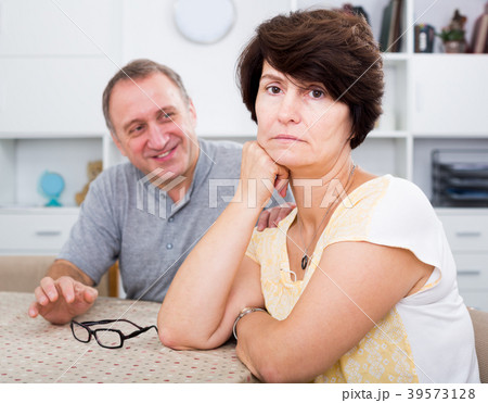 Unhappy mature woman having issues with her husband Unhappy mature woman having issues with her husband 39573128
