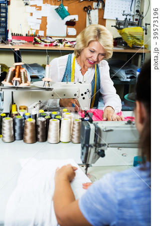 Tailor using sewing machine Tailor using sewing machine 39573196