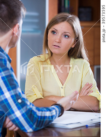 Husband and wife with sad faces discussing finances Husband and wife with sad faces discussing finances 39573595