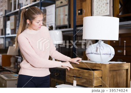 woman consumer choosing chest of drawers woman consumer choosing chest of drawers 39574024