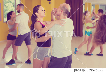Young men and women are dancing waltz in pairs Young men and women are dancing waltz in pairs 39574025