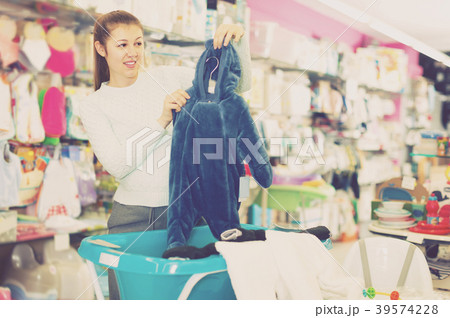 smiling pregnant female is buying clothes for baby in thestore smiling pregnant female is buying clothes for baby in thestore 39574228