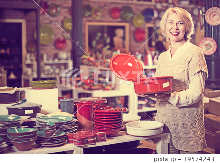 Woman buying ceramic tableware 39574243