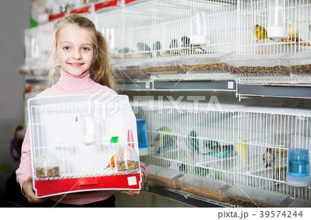 Girl enjoying her purchase of canary bird 39574244