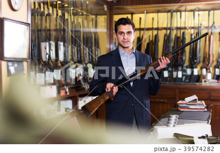 Salesman showing rifle Salesman showing rifle 39574282