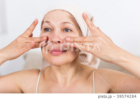 Woman using face cream Woman using face cream 39574284