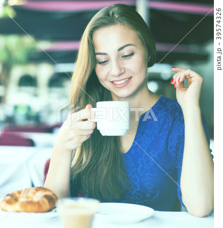 Portrait of elegant female who is enjoying of lunch with coffee Portrait of elegant female who is enjoying of lunch with coffee 39574326