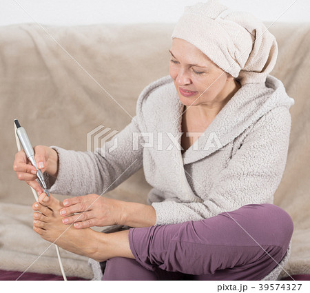Woman doing pedicure Woman doing pedicure 39574327