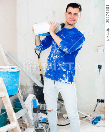 Man holding bag of putty 39574681