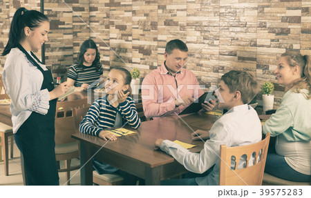 Waitress taking order from guests Waitress taking order from guests 39575283