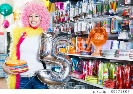 Girl in a wig shows things for a party Girl in a wig shows things for a party 39575307