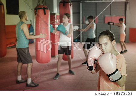 Portrait of girl boxer in boxing hall Portrait of girl boxer in boxing hall 39575553