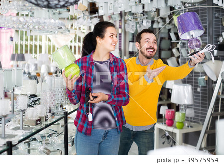 man and girl in lighter shop discussing purchase of bedside lamp for house man and girl in lighter shop discussing purchase of bedside lamp for house 39575954