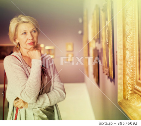 Female visitor looking at artwork painting 39576092