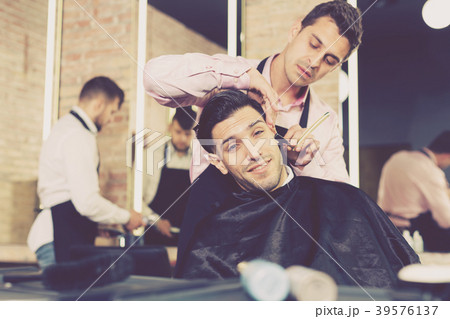 Man during beard shaving in barbershop Man during beard shaving in barbershop 39576137