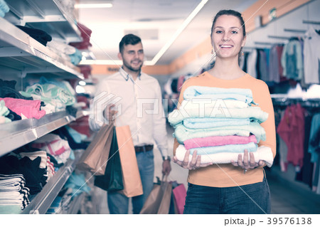 Woman holding towels in shop Woman holding towels in shop 39576138