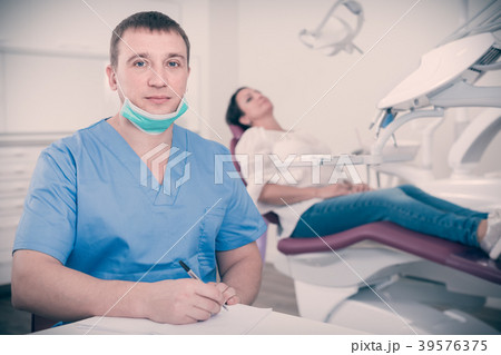 dentist in uniform writing document 39576375