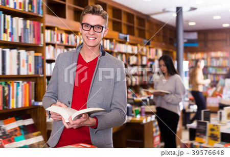 Glad guy reading interesting books Glad guy reading interesting books 39576648