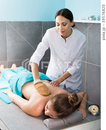 Relaxing girl enjoying beauty treatments in spa center, receiving peeling 39576820