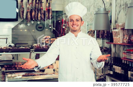 Smiling male seller working at meat market Smiling male seller working at meat market 39577725