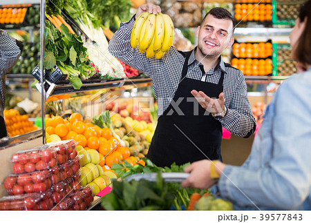 Male seller assisting in buying Male seller assisting in buying 39577843