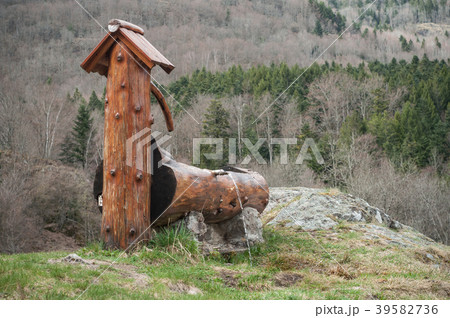 wooden fountain on moutain landscape wooden fountain on moutain landscape 39582736