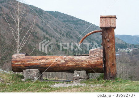 typical wooden fountain on moutain landscape  39582737
