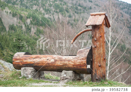 typical wooden fountain on moutain landscape typical wooden fountain on moutain landscape 39582738
