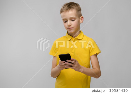 Little blonde caucasian boy in yellow t-shirt 39584430