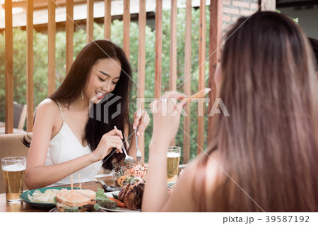 Asian friends enjoying eating turkey at restaurant Asian friends enjoying eating turkey at restaurant 39587192
