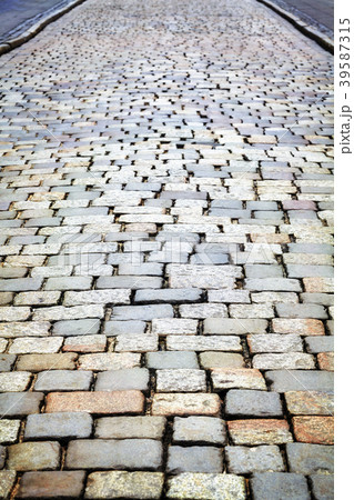 Cobblestone street pavement, urban background. Cobblestone street pavement, urban background. 39587315