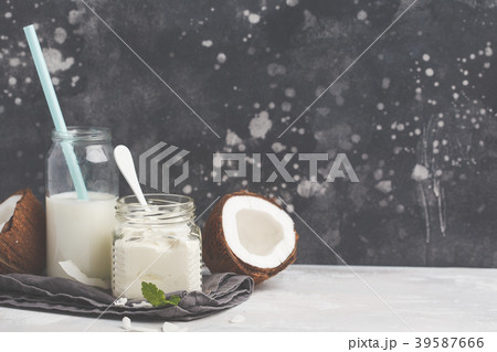 Coconut yoghurt and coconut milk in a glass jar. 39587666